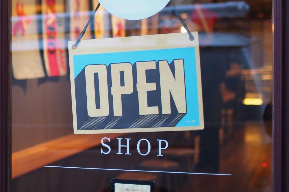 Free Image of Shop open sign hanging on door 