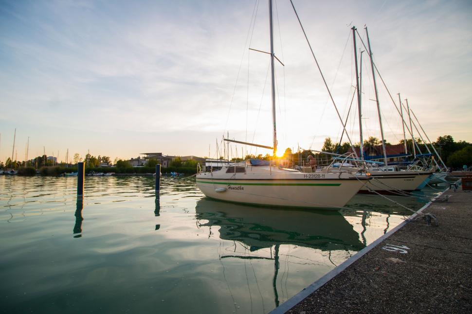 Free Image of Serene harbor sunset with sailboats 