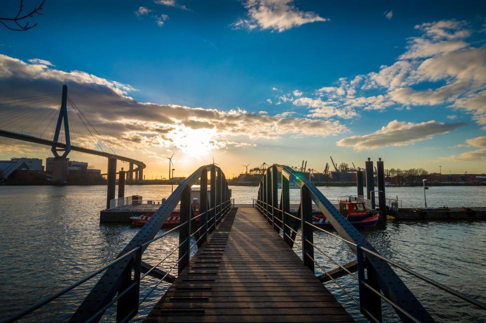 Free Image of Sunset view over a bridge and river setting 