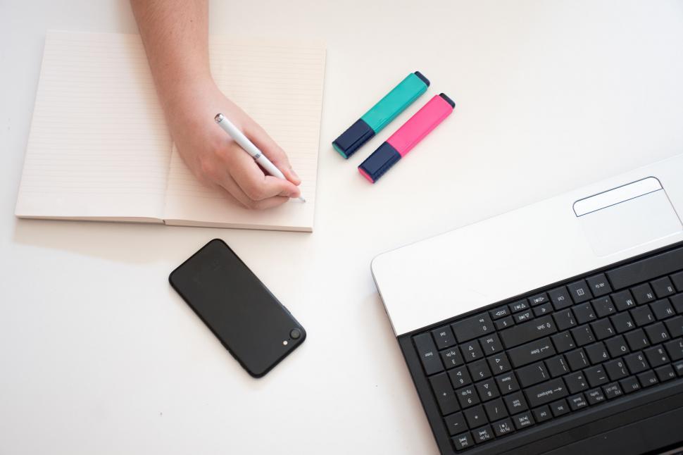 Free Image of Workspace with notebook, phone, and laptop 