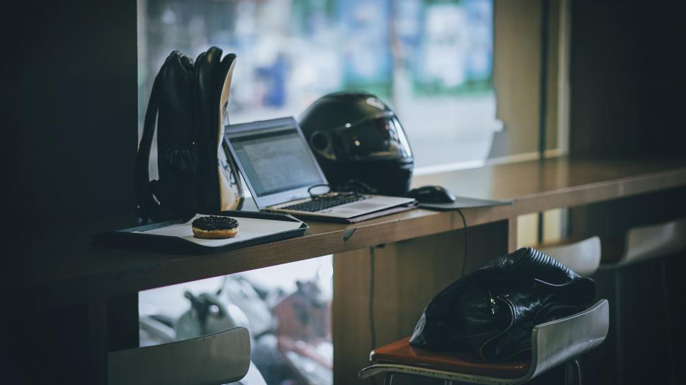 Free Image of Biker work essentials on the table in cafe 