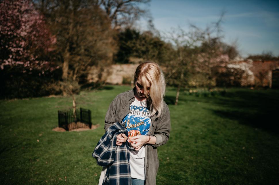 Free Image of Cropped view of person holding jacket in park 