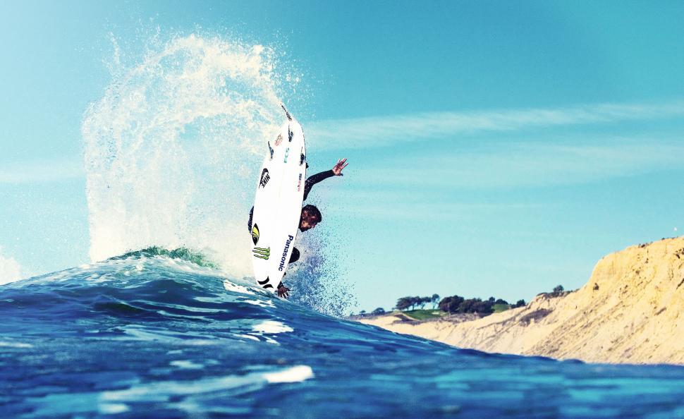 Free Image of Surfer catching a big wave at sea 