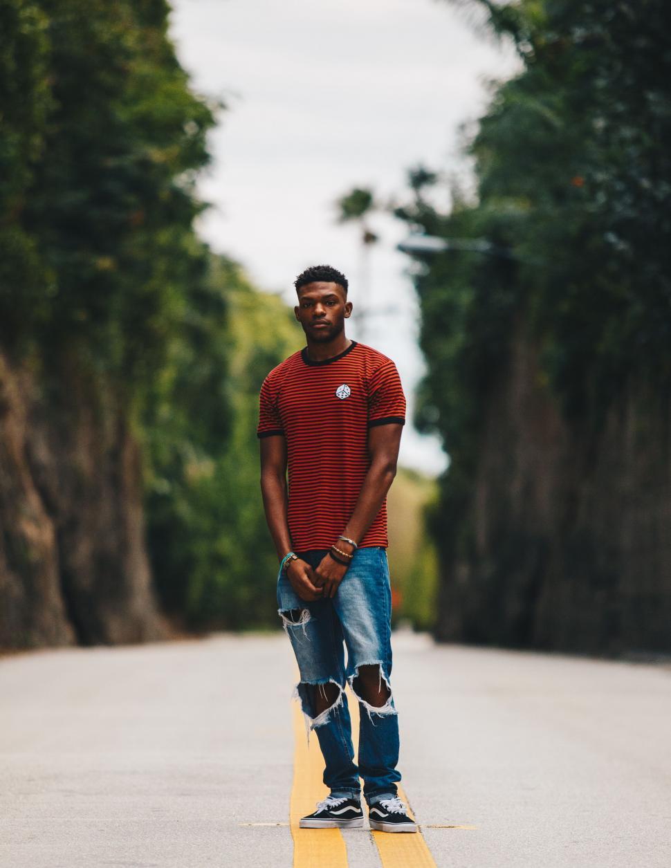 Free Image of Man posing on a road stripe 