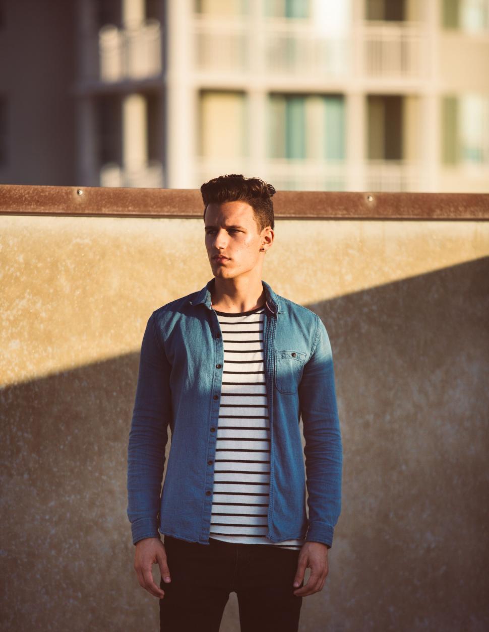 Free Image of Stylish man in urban backdrop 