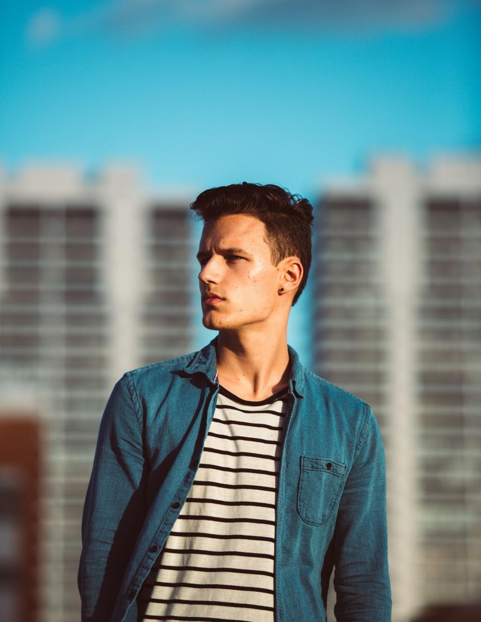 Free Image of Young man in contemplative urban scene 