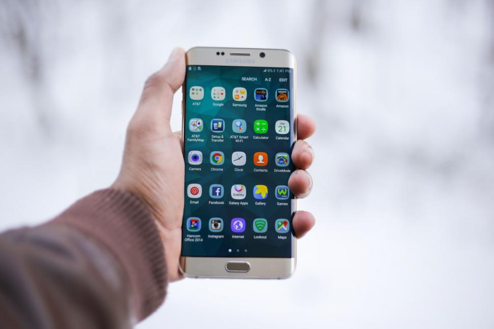 Free Image of Person holding smartphone with app icons 