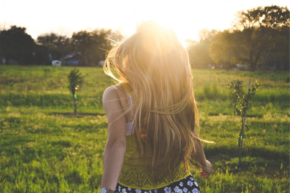 Free Image of Sunlit woman enjoying a field at sunset 