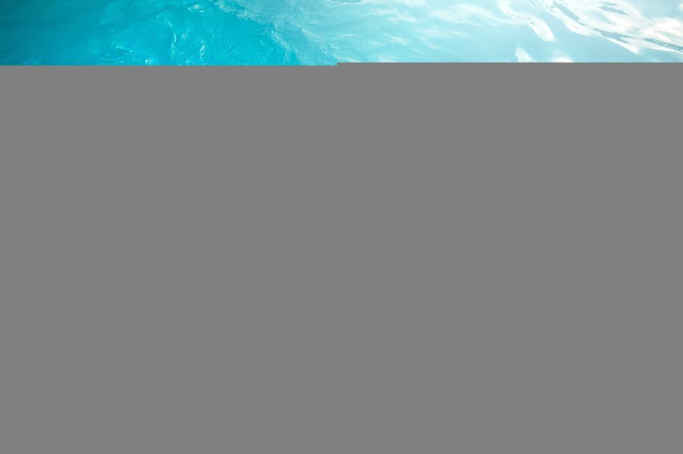 Free Image of Boy floating in pool with swim ring 