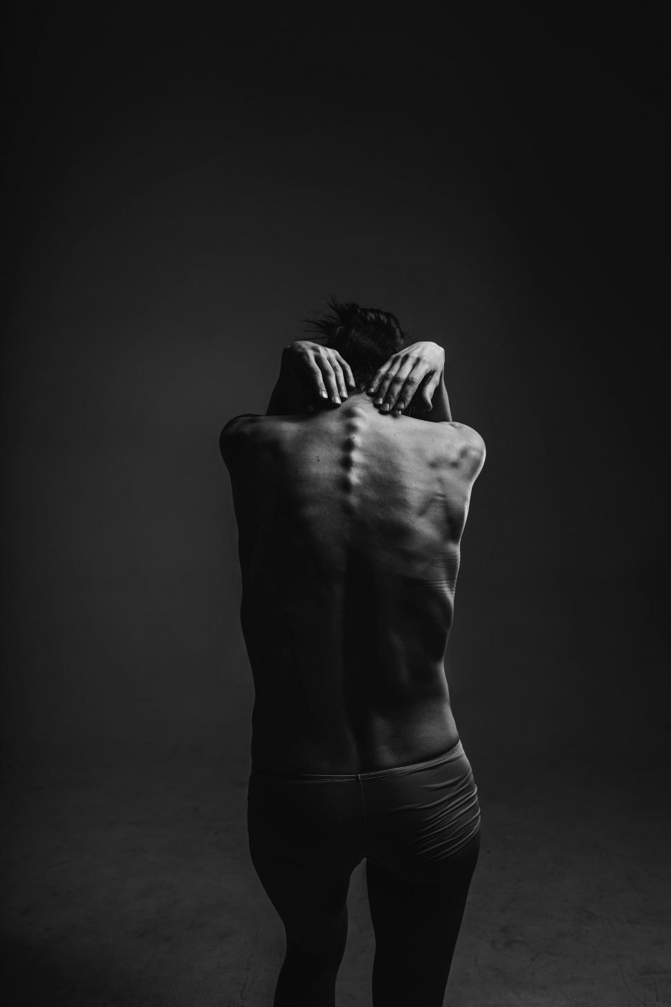 Free Image of Monochrome image of a man holding his head in despair 