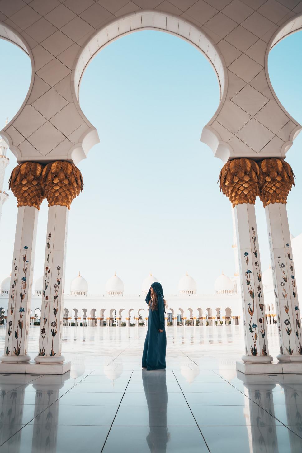 Free Image of Woman in blue dress at architectural marvel 