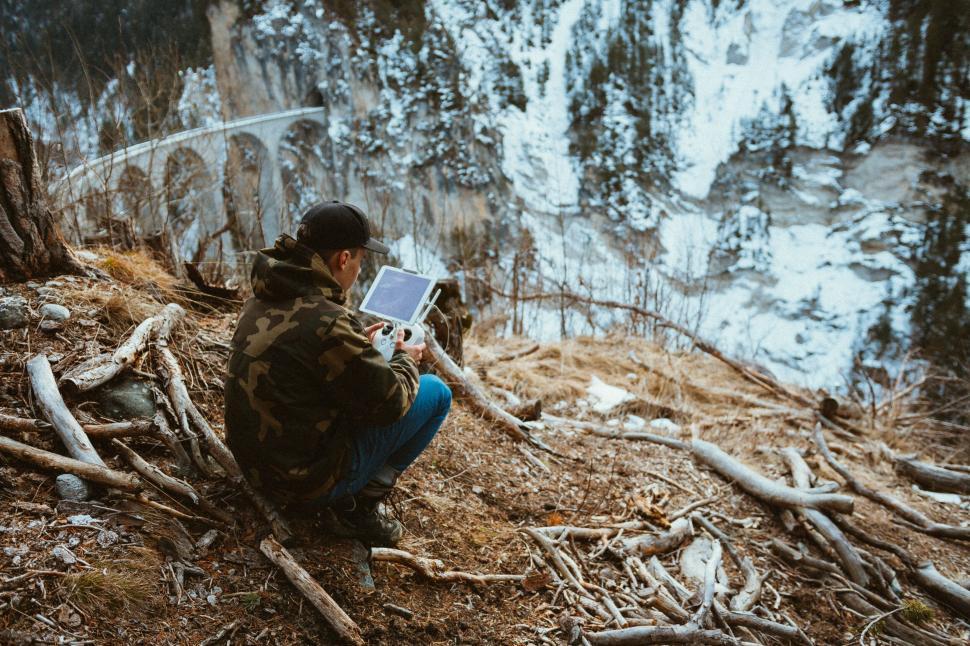 Free Image of Person sitting on the edge of a cliff 