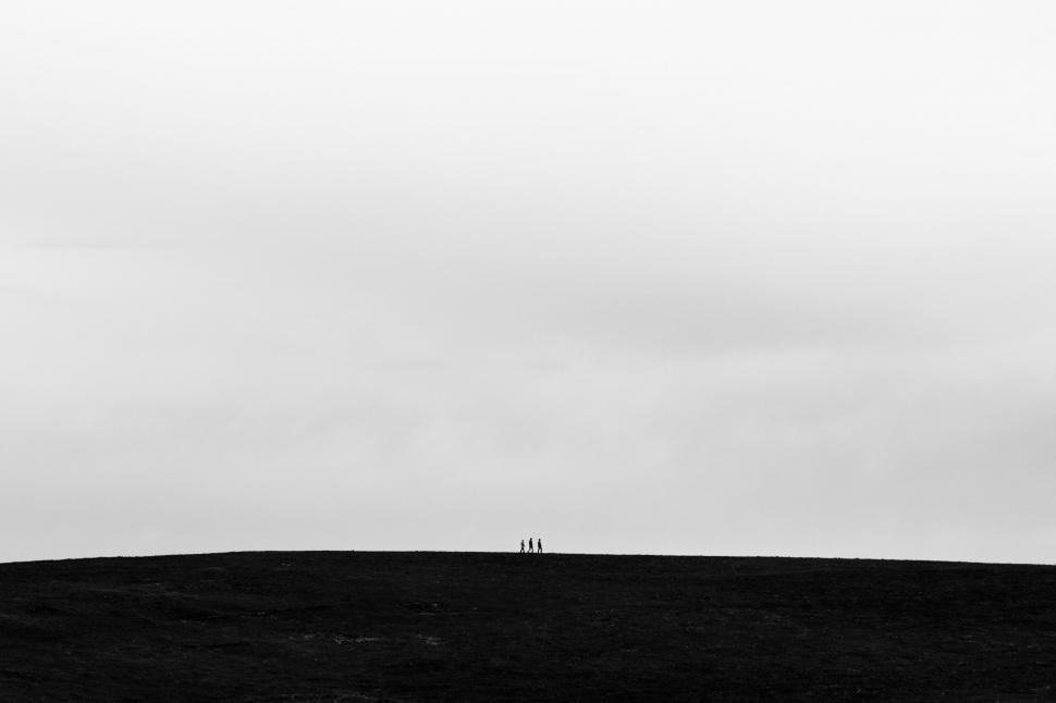 Free Image of Tiny figures on hilltop over cloudy abyss 