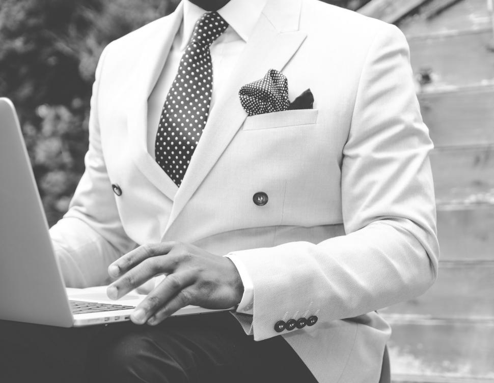Free Image of Businessman working on laptop outdoors 