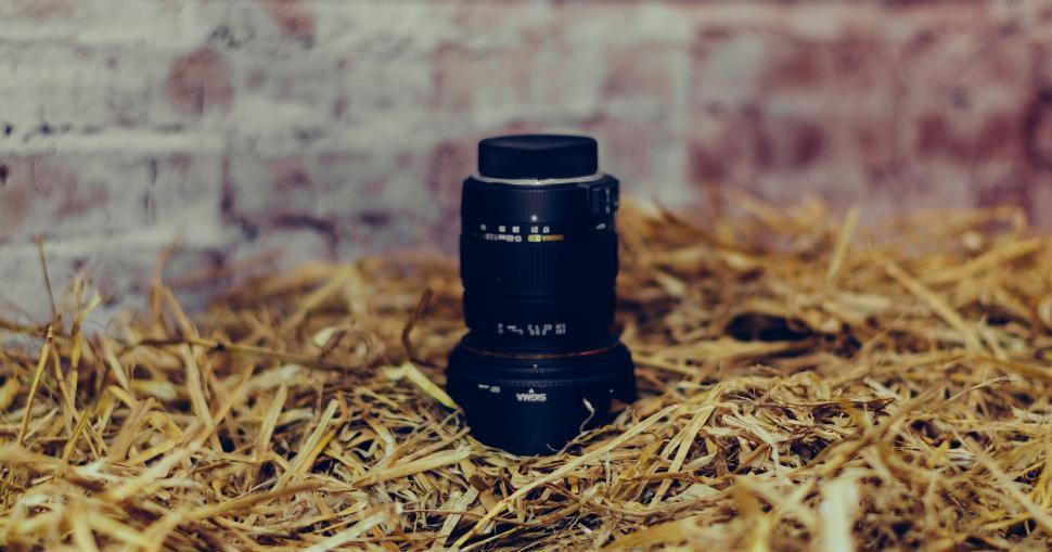 Free Image of Camera lens on straw bed 