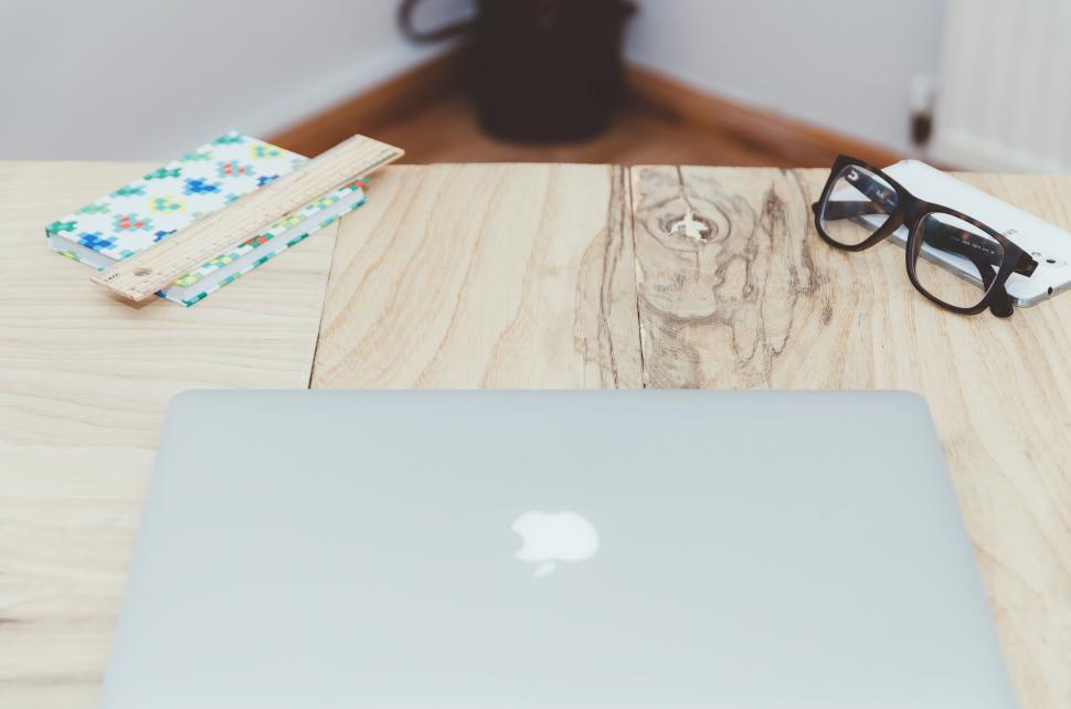 Free Image of Laptop and glasses on a wooden table 