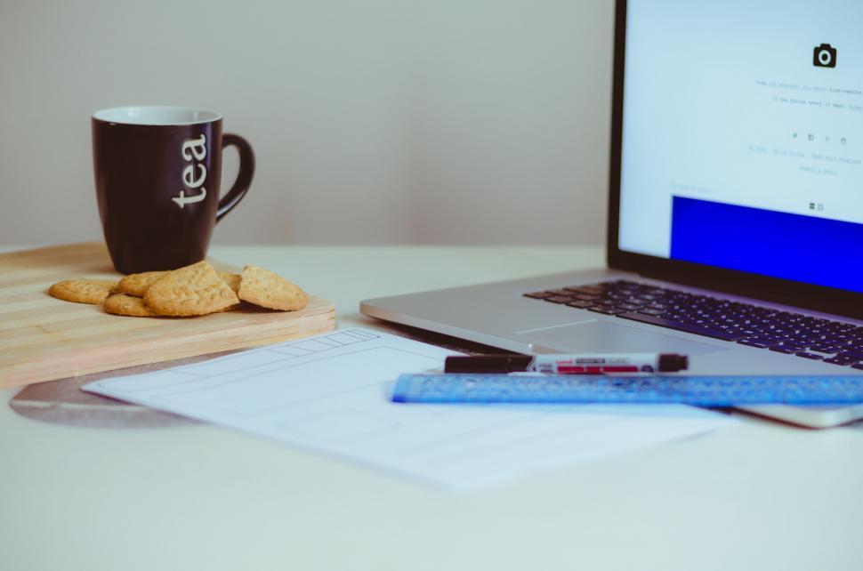 Free Image of Laptop and a cup of tea on desk 
