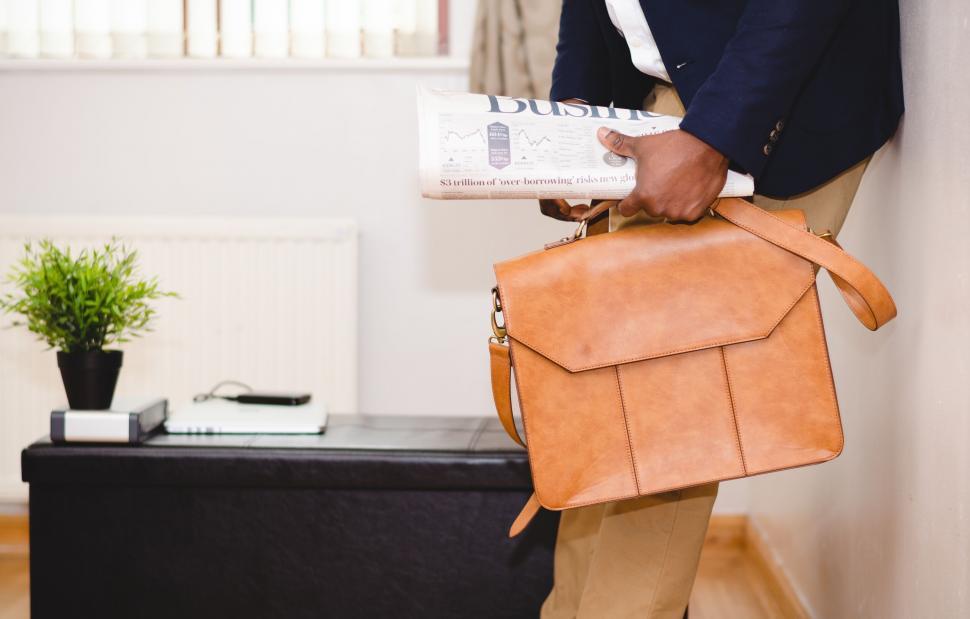 Free Image of Professional with newspaper and briefcase 