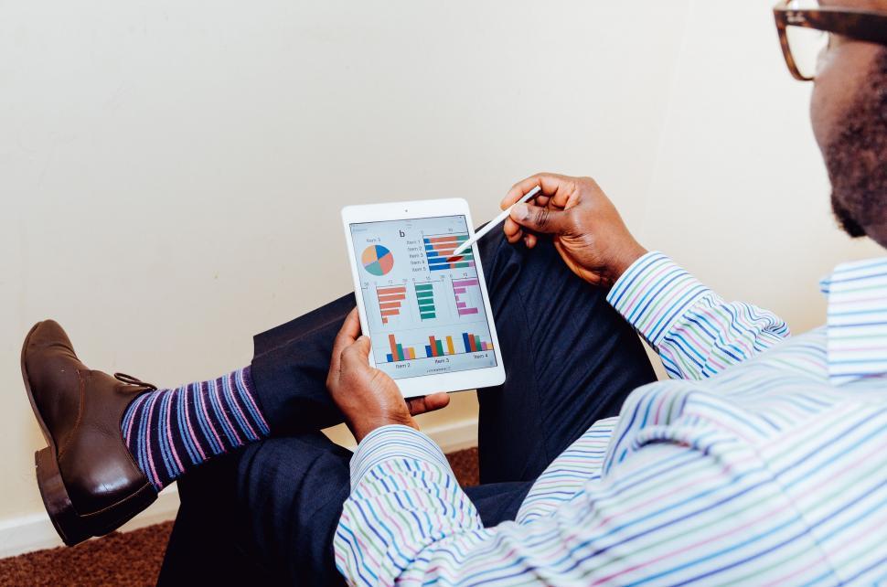Free Image of Man analyzing data on tablet 