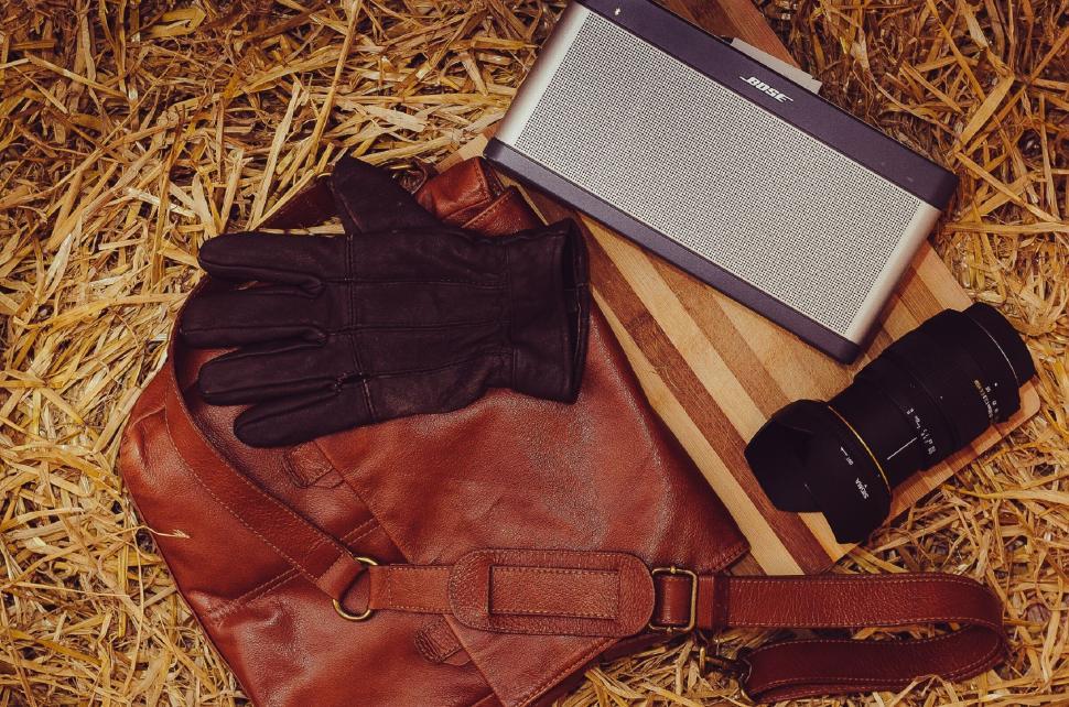Free Image of Vintage style camera and accessories on hay 