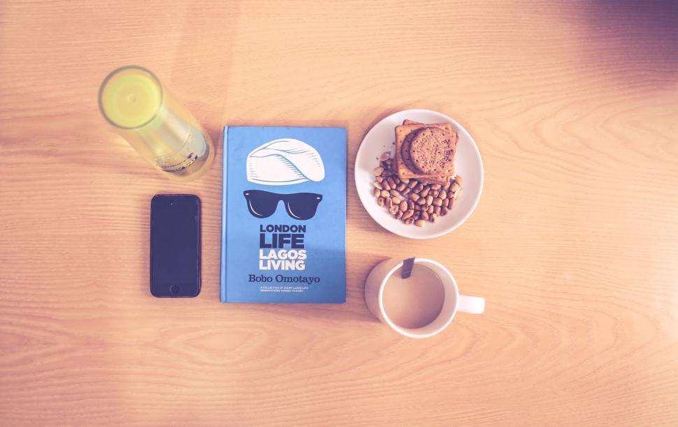 Free Image of Smartphone, book, glass and snack setup 