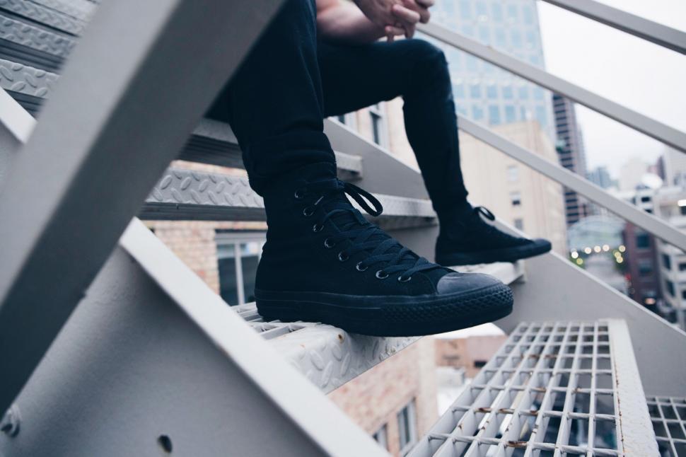 Free Image of Urban look with black sneakers on metal stairs 
