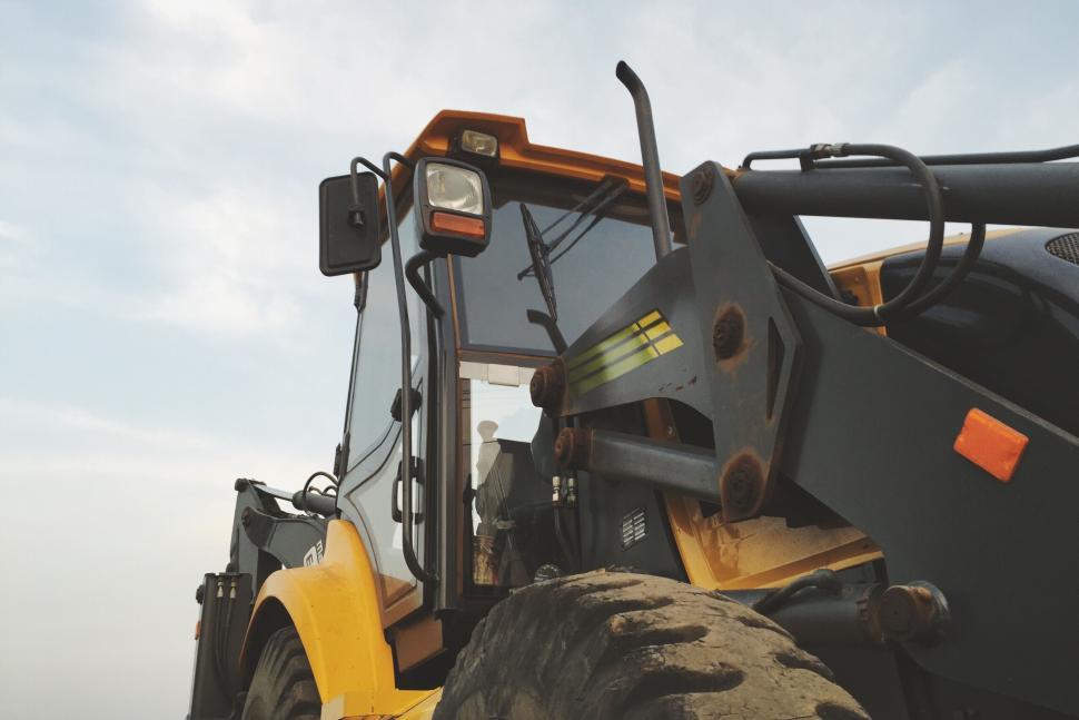 Free Image of Close-up of a heavy machinery wheel and cabin 