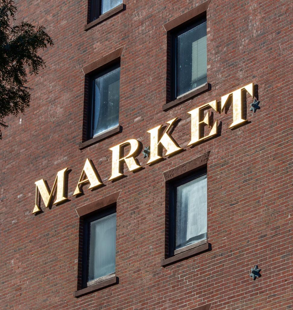 Free Image of Gold  MARKET  sign on brick wall facade 