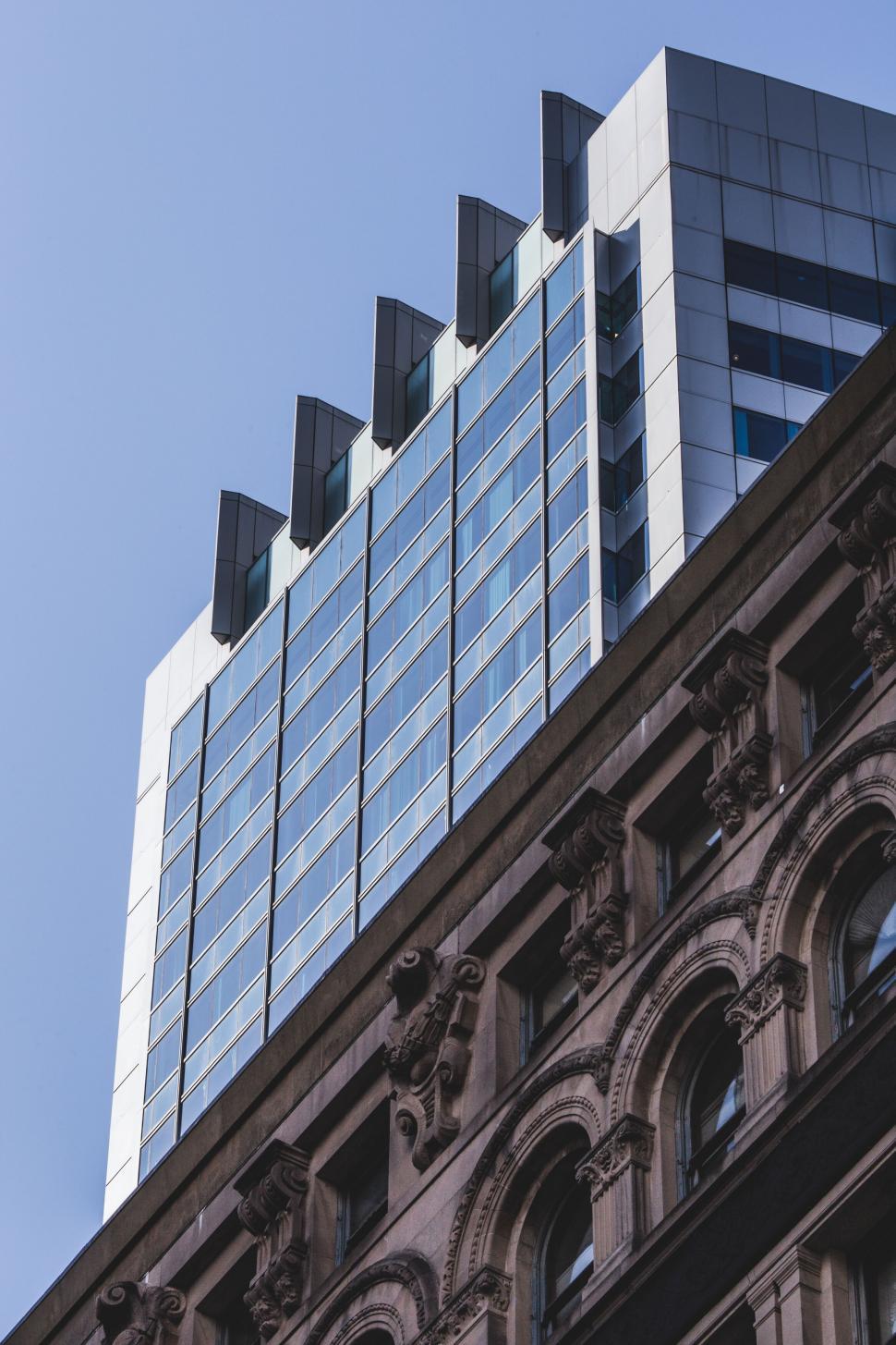 Free Image of Contemporary high-rise with classic architecture below 