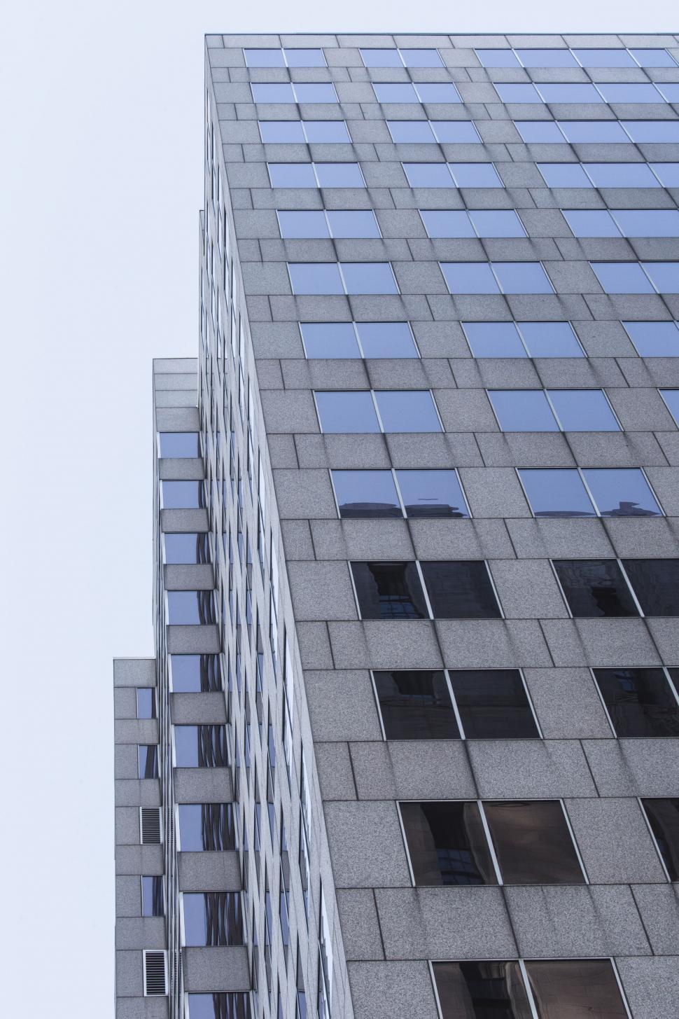 Free Image of Skyscraper with a geometric facade against the sky 
