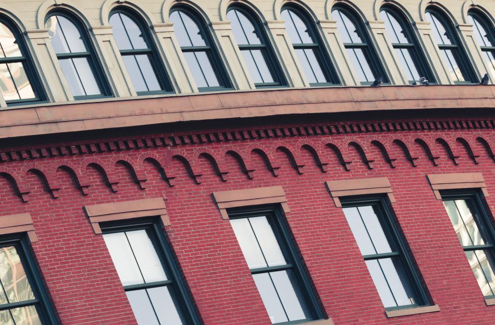 Free Image of Red brick building with arched windows and details 
