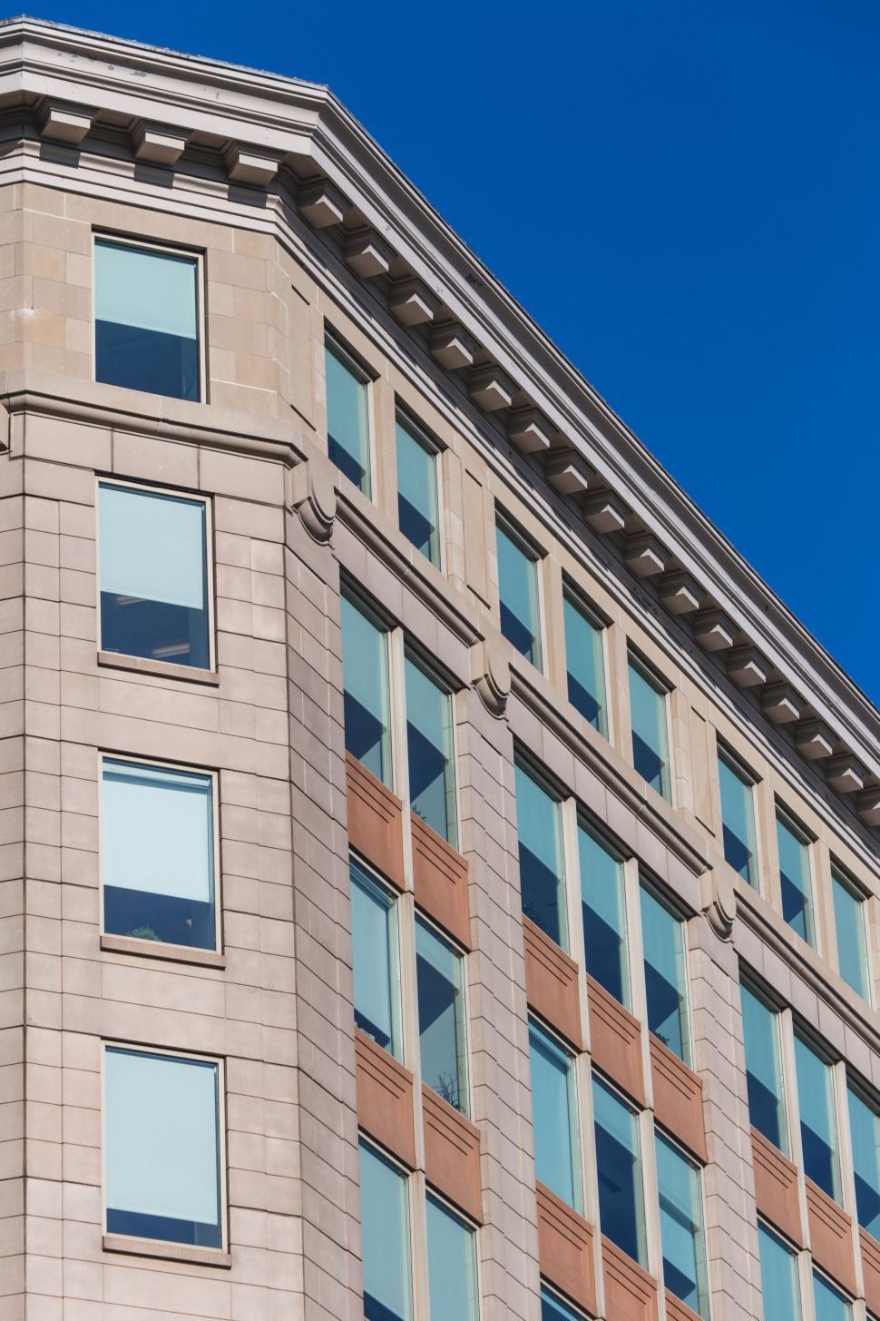 Free Image of Modern beige stone building with blue sky 