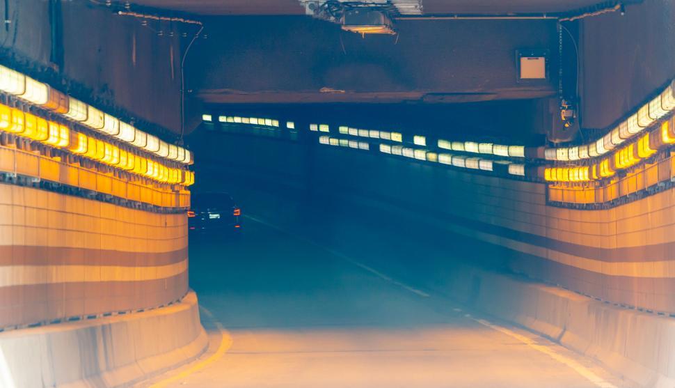 Free Image of Illuminated tunnel entrance with car entering 