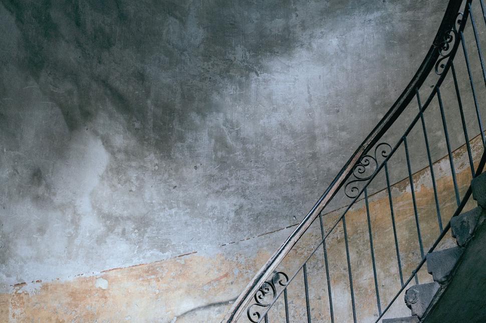 Free Image of Spiral staircase with distressed texture wall 