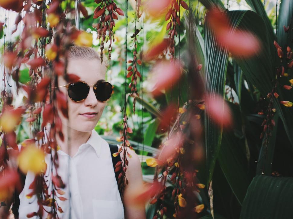 Free Image of Portrait of person amid lush foliage blurred face 