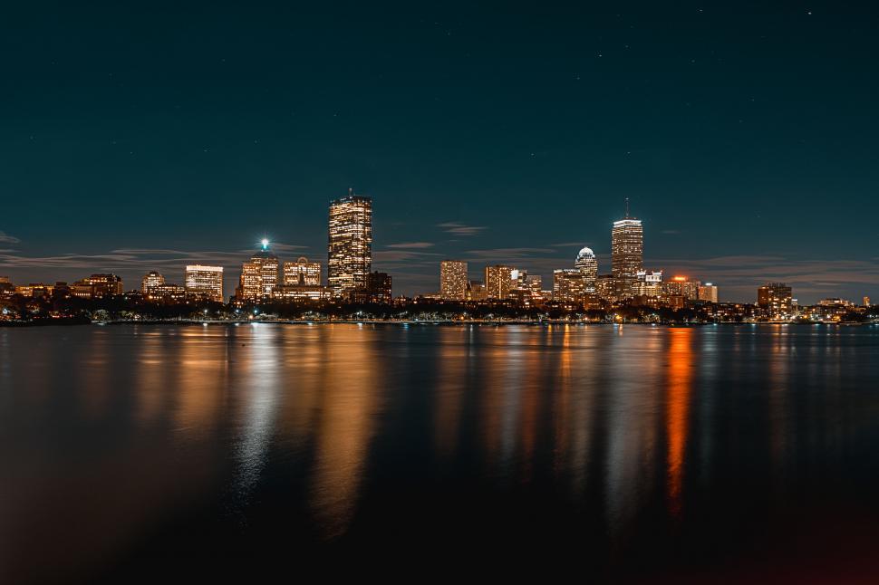 Free Image of Nighttime skyline reflecting on the water 