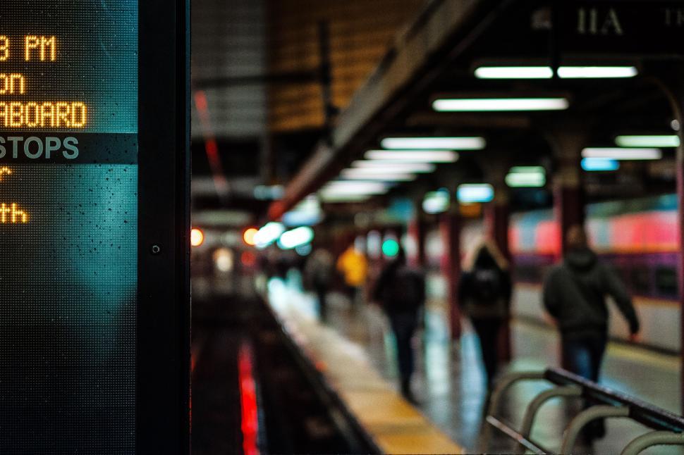 Free Image of Dimly lit train station with busy platform 