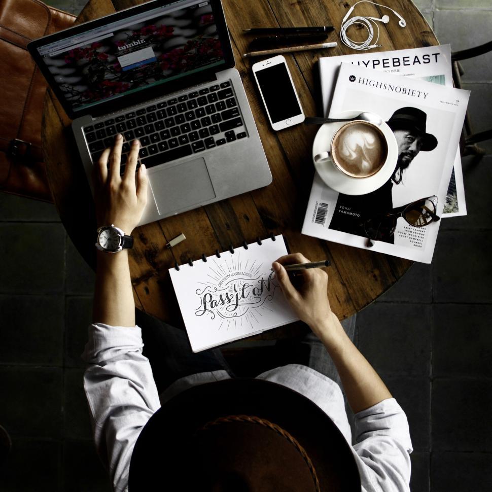 Free Image of Designer at work with coffee and sketches 