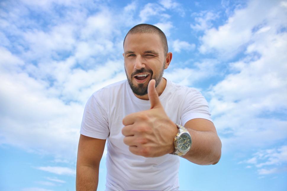 Free Image of Man giving thumbs up against sky 