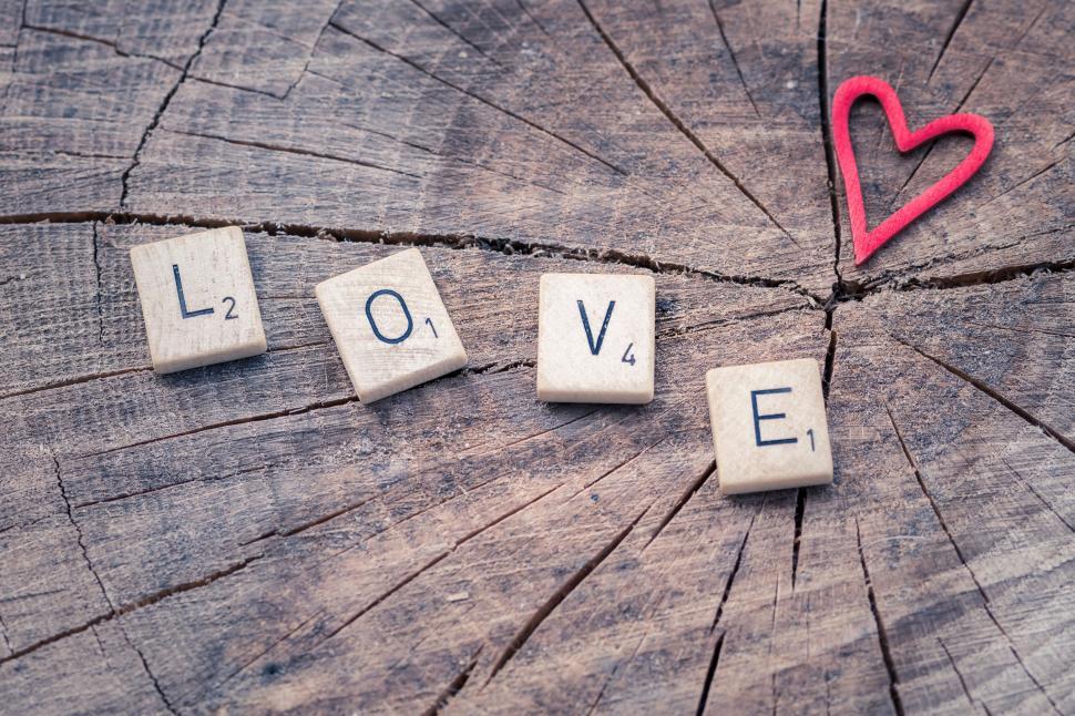 Free Image of Love spelled with wooden letter tiles and heart 