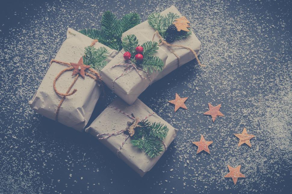 Free Image of Three wrapped gifts with festive decorations 