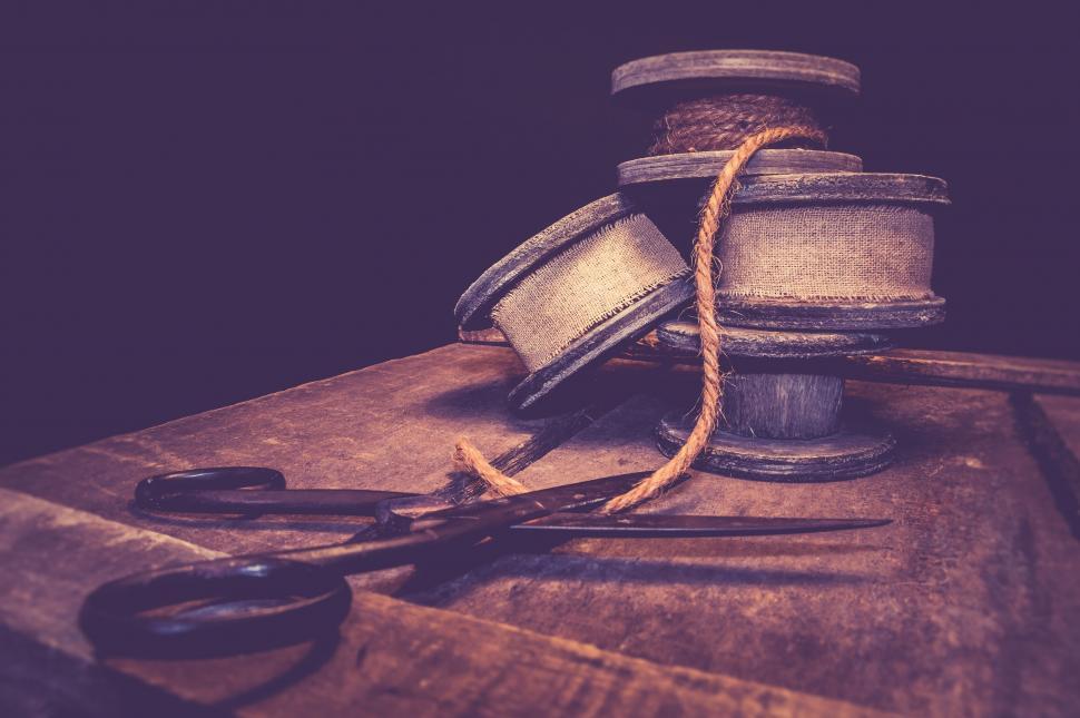 Free Image of Vintage sewing tools on dark wooden background 