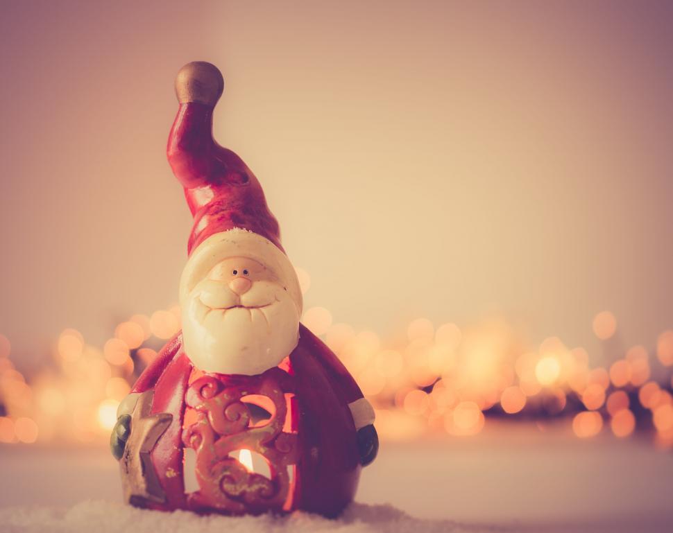 Free Image of Santa Claus figurine on a snowy backdrop 