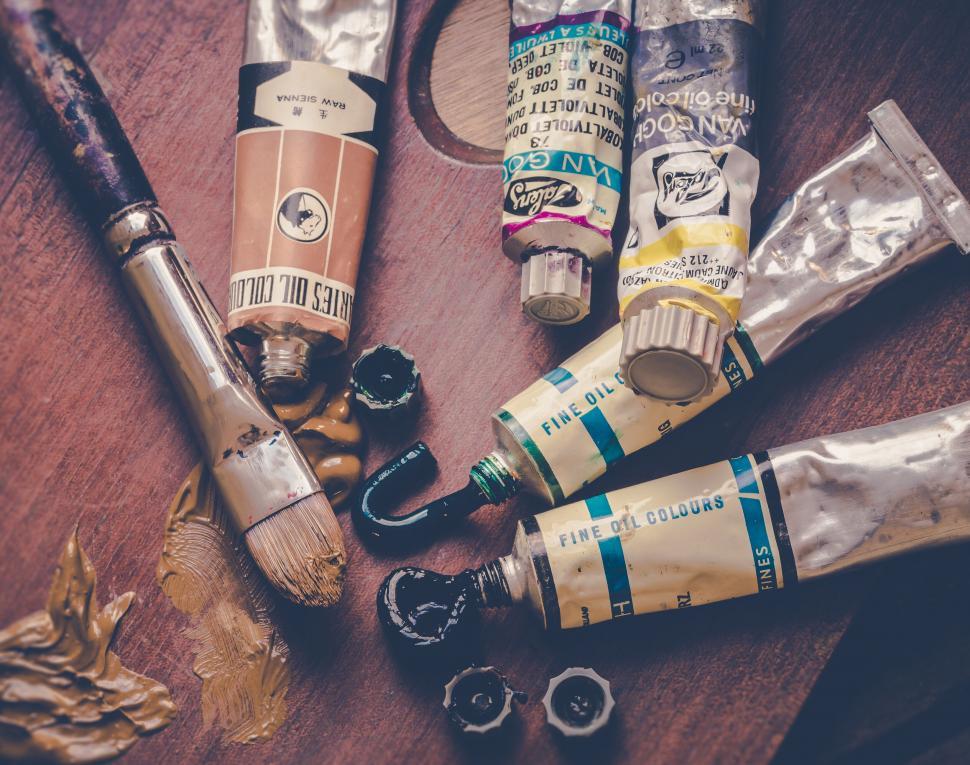 Free Image of Artistic oil paints and brushes on wooden table 