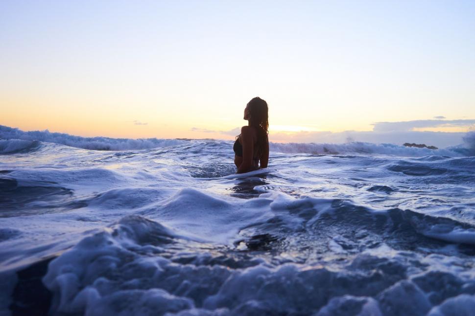 Free Image of Silhouette of a woman in ocean waves 