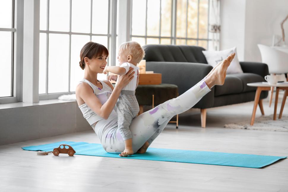 Free Image of Mother practicing yoga with baby 