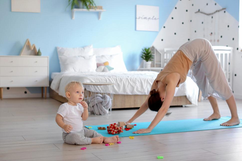 Free Image of Yoga practice with mother and playful toddler 