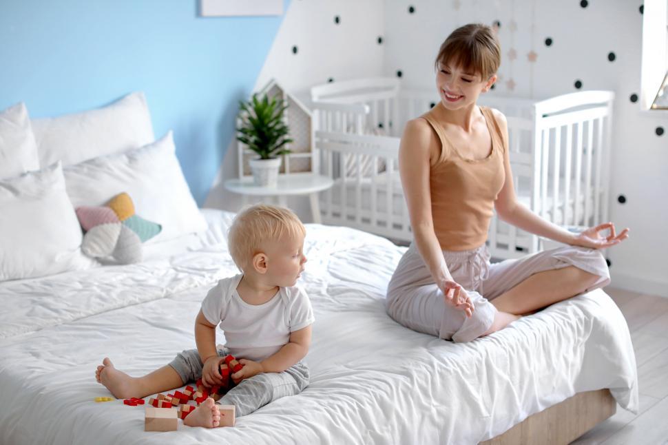 Free Image of Mother and child in bright nursery room 