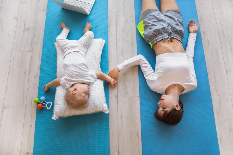 Free Image of Mother and baby exercising at home 