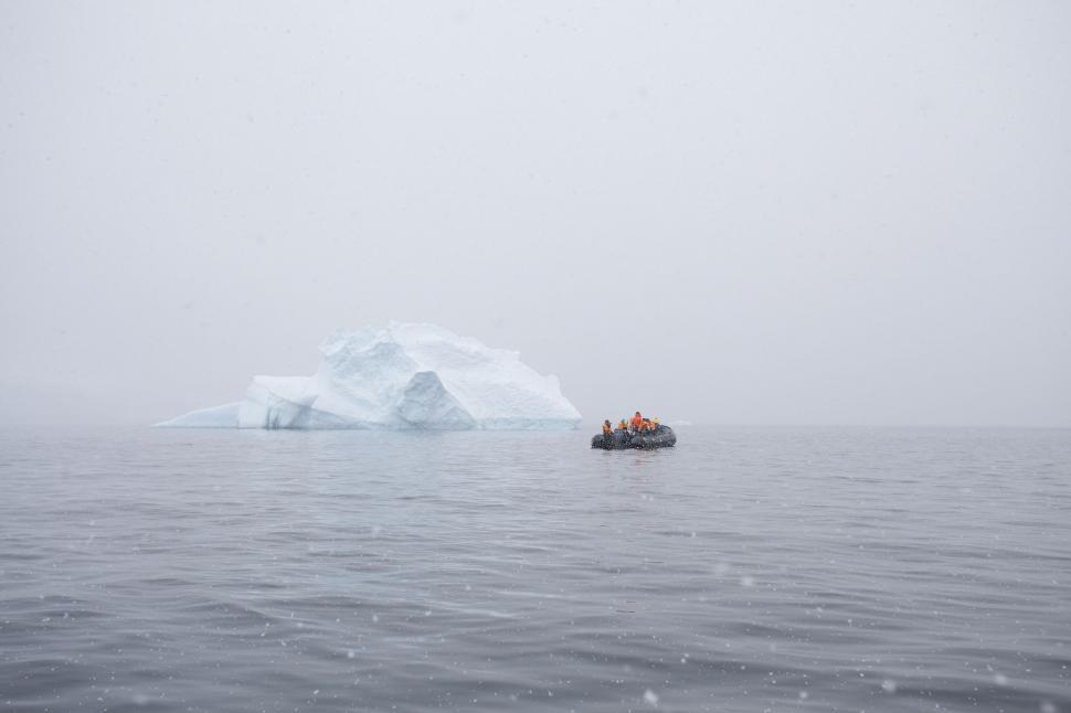 Free Image of Boat near iceberg in misty sea 